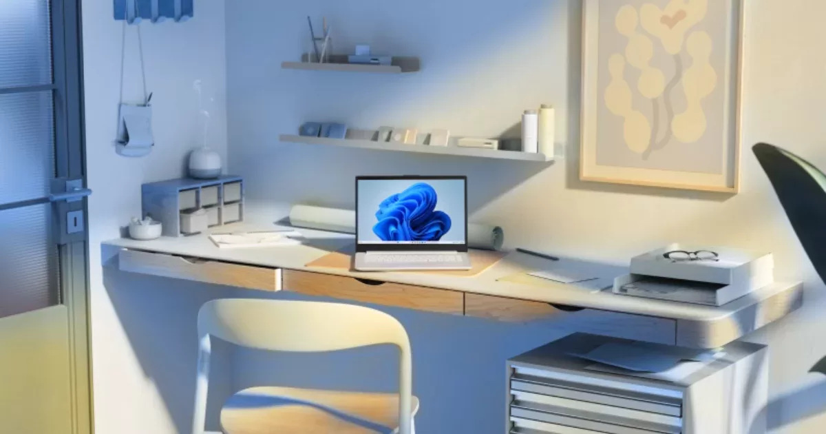 Nyitott laptop Windows 11 háttérképpel egy íróasztalon